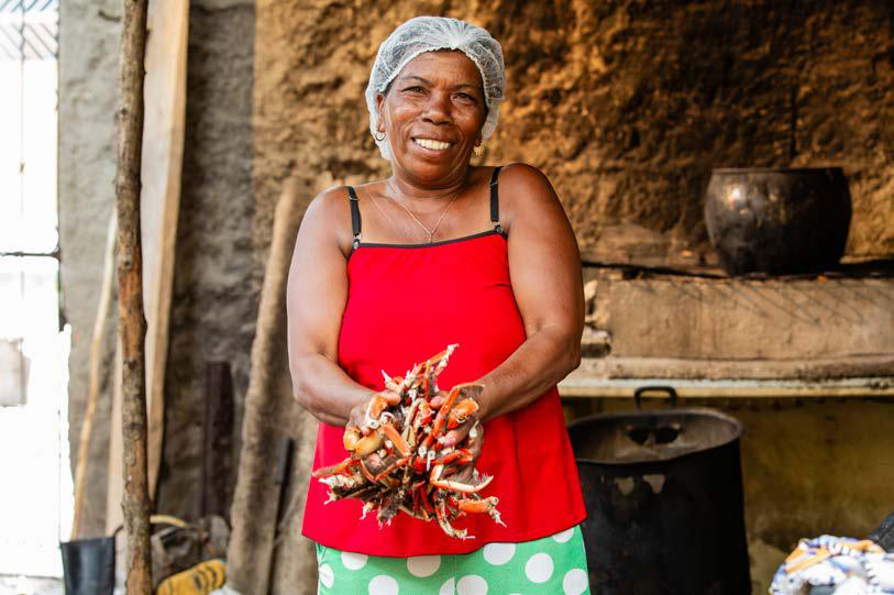 Mulher com caranguejos no litoral sul da Bahia